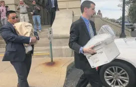  ?? JOHN O’CONNOR/AP ?? Agents carry boxes and a bag marked “evidence” in September from the state Capitol after a raid at the office of then-state Sen. Martin Sandoval.