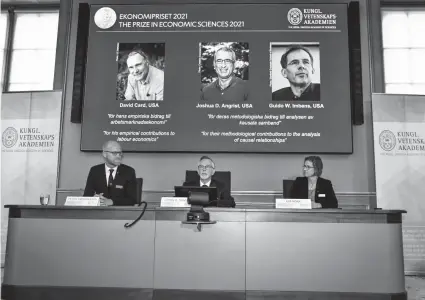  ?? CLAUDIO BRESCIANI/AP ?? Nobel Prize winners, from left, David Card, Joshua Angrist and Guido Imbens discuss their studies Monday at the Royal Swedish Academy of Sciences.