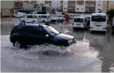  ?? — Photo by Juidin Bernarrd ?? A motorist drives through a waterlogge­d road in Al Qusais, Dubai.