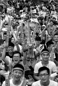  ??  ?? Same-sex activists hug outside the parliament in Taipei on May 24.