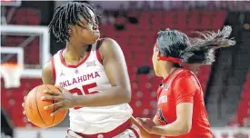  ?? [PHOTO BY SARAH PHIPPS, THE OKLAHOMAN] ?? Oklahoma’s Madi Williams (25) looks to pass the ball around Texas Tech’s Eryka Sidney (3) on Wednesday.