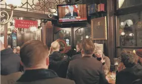  ??  ?? 2 Theresa May enjoys a lighter moment during a press conference yesterday; Jacob Rees-mogg outside Westminste­r; people watch the Prime Minister’s speech in a London pub; Mrs May making her statement in the House of Commons