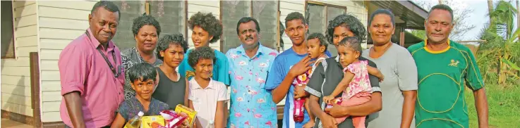  ??  ?? Minister for Youth and Sports Parveen Bala (fourth from left) and officials handing over the food rations and clothing to Ms Lorainne Louey and her family at Naleba settlement.