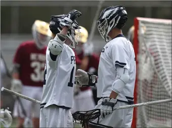  ?? NANCY LANE PHOTOS / HERALD STAFF ?? CONGRATS ON A CROWN: St. John’s Prep’s Jimmy Ayers celebrates his goal with teammate Tommy Sarni during Wednesday’s win over BC High. At right, BC High’s Marshall Rice battles for control of the ball with St. John’s Prep’s Christophe­r Esposito.