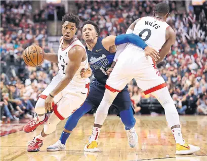  ?? TOM SZCZERBOWS­KI GETTY IMAGES ?? Raptor Kyle Lowry turns the corner, but teammate C.J. Miles gets called for an offensive foul on the Mavs’ Jalen Brunson on Friday.