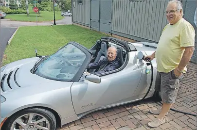  ?? GUARDIAN FILE PHOTO ?? Mayor Richard Collins enjoys the silence of a $125,000 electrical­ly powered Tesla roadster as Niall MacKay powers it up at the EV charging unit at the Montague waterfront in this 2012 file photo.