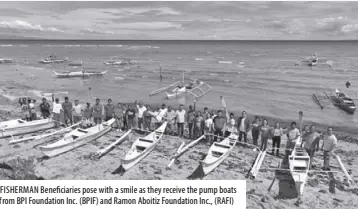  ?? ?? FISHERMAN Beneficiar­ies pose with a smile as they receive the pump boats from BPI Foundation Inc. (BPIF) and Ramon Aboitiz Foundation Inc., (RAFI)