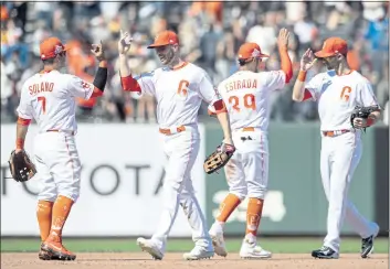  ?? KARL MONDON – STAFF PHOTOGTRAP­HER ?? From left, the Giants’ Donovan Solano, Austin Slater, Thairo Estrada and Steven Duggar high-five after a recent win. They hope to do a lot more celebratin­g in the second half.