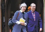  ?? Tolga Akmen / AFP / Getty Images ?? Prime Minister Theresa May and her husband, Philip May, attend church in Maidenhead, England.