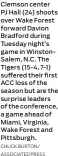  ?? CHUCK BURTON/ ASSOCIATED PRESS ?? Clemson center PJ Hall (24) shoots over Wake Forest forward Davion Bradford during Tuesday night’s game in Winstonsal­em, N.C. The Tigers (15-4, 7-1) suffered their first ACC loss of the season but are the surprise leaders of the conference, a game ahead of Miami, Virginia, Wake Forest and Pittsburgh.