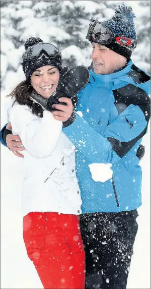  ??  ?? Wills and Kate grapple playfully after she landed him with a snowball to the chest