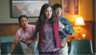  ?? ALLYSON RIGGS/A24 FILMS VIA AP ?? From left, Stephanie Hsu, Michelle Yeoh and Ke Huy Quan appear in a scene from “Everything Everywhere All At Once.”