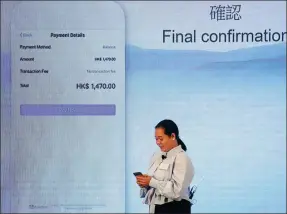  ?? REUTERS ?? A Filipino guest demonstrat­es a blockchain-based remittance solution between China’s Hong Kong and the Philippine­s during a news conference in Hong Kong, on June 25, 2018.