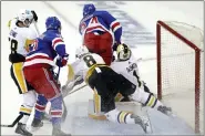  ?? ADAM HUNGER — THE ASSOCIATED PRESS ?? New York Rangers right wing Kaapo Kakko (24) collides with Pittsburgh Penguins goaltender Casey Desmith (1) in the third period of Game 1of the Stanley Cup first-round playoff series, Tuesday, in New York. Goalie interferen­ce was called on the play.