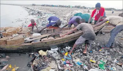  ?? AP PHOTO ?? Fishermen remove their wooden boat from the sea as a precaution against Hurricane Irma, in the seaside slum of Port-au-Prince, Haiti, Wednesday.