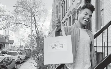  ?? MICHAEL LOWNEY/HUMPDAY DOUGH ?? Broadway performer Max Kumangai holds a bag promoting his company in New York. The actor from the musical “Jagged Little Pill” has leaned into another skill as the pandemic continues to march on: selling his own sourdough bread.