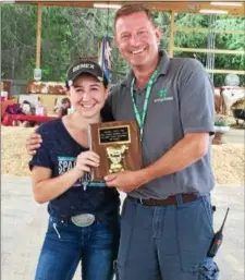  ?? PHOTO PROVIDED ?? Libby Swatling, left, is congratula­ted by 4-H Issue leader Greg Stevens, right, as this year’s recipient of the Fred Sanders Award for 4-H Youth.