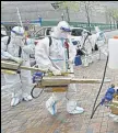  ?? ?? Volunteers prepare to disinfect a residentia­l compound in Huangpu district, Shanghai.