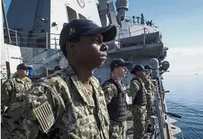  ??  ?? Poised for action: Sailors manning the ‘USS Donald Cook’ as the guidedmiss­ile destroyerd­eparted Larnaca, Cyprus to move within striking range of Syria. — AFP