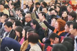  ?? LIU JINHAI / XINHUA FENG YONGBIN / CHINA DAILY ?? Spokesman for the 19th National Congress of the Communist Party of China Tuo Zhen (center) answers questions from journalist­s at a news conference at the Great Hall of the People on Tuesday in Beijing.