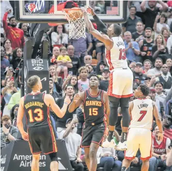  ?? AL DIAZ adiaz@miamiheral­d.com ?? Heat center Bam Adebayo dunks against the Hawks at the FTX Arena in Miami on April 8. Miami defeated Atlanta in three of their four meetings during the regular season, although both teams were missing key players.