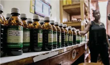  ?? Charlie Shoemaker / New York Times ?? Bottles of liquid morphine are readied for shipment in a facility in Kampala. Uganda has an innovative strategy for giving increasing­ly scarce morphine to patients in pain.