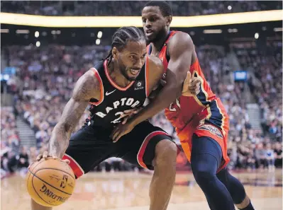  ??  ?? Raptors forward Kawhi Leonard (2) drives to the net as New Orleans Pelicans forward Darius Miller (21) defends during firsthalf NBA action in Toronto on Monday. New Orleans won 126-110.