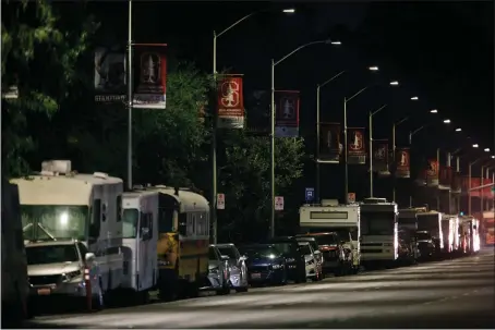  ?? DAI SUGANO — STAFF PHOTOGRAPH­ER ?? RVs, vans and a bus line El Camino Real next to Stanford’s Palo Alto campus. On any given night, dozens of people sleep here in their vehicles.