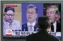  ?? LEE JIN-MAN - THE AP ?? In this March 27, 2018 photo, a man watches a TV screen showing file footages of U.S. President Donald Trump, right, South Korean President Moon Jae-in, center, and North Korean leader Kim Jong Un, left, during a news program at the Seoul Railway...