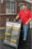  ?? LAUREN HALLIGAN — LHALLIGAN@ DIGITALFIR­STMEDIA.COM ?? Albert Deeb, manager of Jack’s Drive In, sets up a new menu sign outside of the eatery.