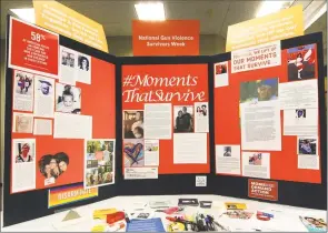  ??  ?? A view of the Moments That Survive Story Wall on display during a special statewide event hosted by Moms Demand Action for Gun Sense in America at the Margaret Morton Government Center in Bridgeport on Saturday. The wall is a display of photos and personal stories from Connecticu­t gun violence survivors that illustrate the effect gun violence has had on their lives.
At left, Laura Slinsky, whose son Shane was murdered in 2016, wipes away a tear as Michele Voigt, with Moms Demand Action for Gun Sense in America, hands her an orange rose.