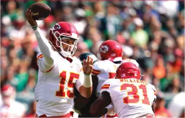  ?? AP ?? Patrick Mahomes threw three of his touchdown passes to Tyreek Hill as the Chiefs beat the Eagles to end a two-game skid.