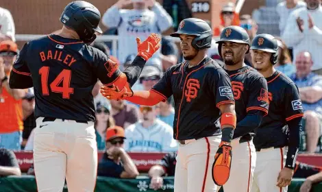  ?? Ross D. Franklin/Associated Press ?? Patrick Bailey, left, and the Giants won’t have a televised spring training game until Saturday against the A’s.