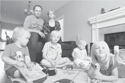  ?? Stuart Gradon/calgary Herald ?? Greg and Ainsley Tymchyna, with their children, from left, Reid, 2, Avery, 6, baby Natalie, and Taylor, 4, in the Calgary show home they’ve been living in since being flooded out of their High River home. Ainsley says living in a trailer for a year...