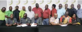  ?? ?? Signing the agreement, seated from left to right: Spencer Tikoane (AMCU), Xolisa Ludidi (AMCU), Hope Tyira (SBPM), Geoffrey Moatshe (NUM), Victor Pilane (NUM) and Sindiswa Maqina (NUM).