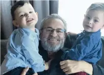  ?? FACEBOOK PHOTO ?? Larry Wahl, longtime spokesman for the Orange Bowl Committee, Miami Hurricanes, New York Yankees and more, is shown holding his two grandsons.