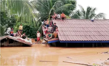  ??  ?? File photo shows villagers evacuate after the Xepian-Xe Nam Noy hydropower dam collapsed in Attapeu province, Laos. — Reuters photo