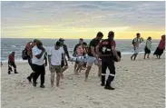  ?? ?? WORKING TOGETHER: A group of Gqeberha residents have been hailed as heroes after selflessly risking their lives to save three people from the surf at Sardinia Bay on Sunday