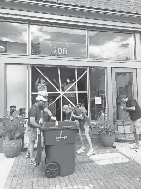  ??  ?? The community came out to help clean up after looters broke into the shop The ZEN Succulent in downtown Raleigh, N. C. COURTESY OF MEGAN GEORGE CAIN