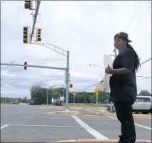  ?? STAFF PHOTOS BY TAMARA WARD ?? Crystal Chase of St. Leonard protests against high-speed police chases and runs at the intersecti­on of Route 231 and Route 4 in Prince Frederick on Saturday. In the distance, other protesters flank the opposite corners holding signs demanding police...