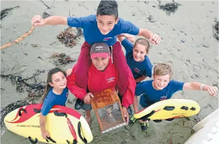  ??  ?? Junior high: Maranui Surf Life Saving Club captain Marc Pulepule with, from left, daughter Asha, 9, son Che, 12, on his shoulders, Sophie Irving, 11, and Lukas Kelly-Heald, 8.