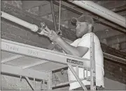  ??  ?? Jacob Swann with Rome Mechanical does plumbing work in the food-court section of a building at 114 Broad St. The project has been through the Historic Preservati­on Commission twice to get approvals for different parts of the renovation.