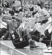  ?? Michael Dwyer Associated Press ?? MILWAUKEE’S Eric Bledsoe, left, tries to circumvent Boston’s Shane Larkin during Game 1.