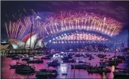  ?? MARK BAKER / AP ?? Fireworks explode over the Sydney OperaHouse and Harbour Bridge asNewYear celebratio­ns begin in Sydney, Australia, on Thursday.