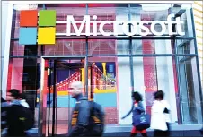  ??  ?? This file photo taken on Oct 6, 2015, shows people walk past a Microsoft office in New York. Windows 10 is now in use in 270 million devices, the tech giant said March 30, 2016, hailing a strong debut for the multiplatf­orm operatings­ystem launched last year. (AFP)