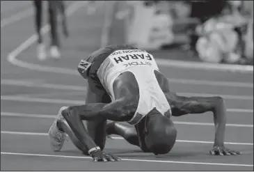  ?? The Associated Press ?? HOMETOWN HERO: Britain’s Mo Farah celebrates after winning the gold medal in the men’s 10,000 meters during the World Athletics Championsh­ip Friday in London.