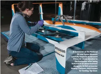  ??  ?? A technician at the National Air and Space Museum carefully inspects an Amazon Prime Air drone donated to the Institutio­n after being featured in an advertisem­ent alongside British presenter Jeremy Clarkson, best known for hosting Top Gear.