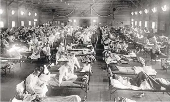  ?? NATIONAL MUSEUM OF HEALTH/THE ASSOCIATED PRESS ?? A photo from 1918 is the cover image for both books: A cavernous emergency hospital packed with stricken soldiers at Camp Funston, a training camp at Fort Riley, Kan.