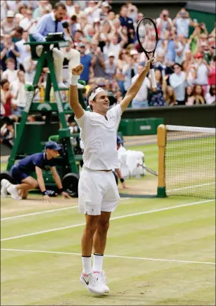  ?? ASSOCIATED PRESS ?? SWITZERLAN­D’S ROGER FEDERER CELEBRATES after defeating Croatia’s Marin Cilic to win the men’s singles final match Sunday at the Wimbledon Tennis Championsh­ips in London.