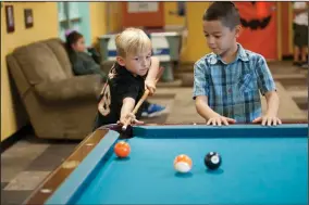  ?? BEA AHBECK/NEWS-SENTINEL ?? Jushua Hall and Alex Perez, both 6, play pool at the Lodi Boys and Girls Club in Lodi on Oct. 4, 2018. The club is striving to avoid the funding problems it faced in 2018.